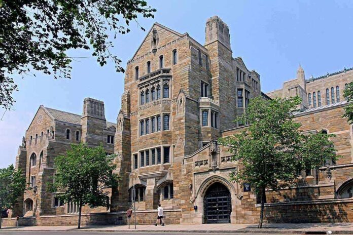 Historic university building with stone facade and surrounding trees