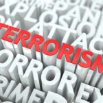 The word TERRORISM in bold red letters surrounded by related terms in white