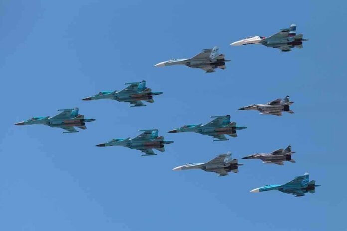 shutterstock_141377446.jpg A formation of military jet fighters flying in a clear blue sky