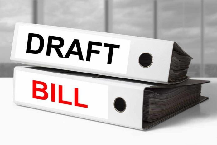 Two file folders labeled DRAFT and BILL stacked on a desk