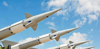 Missiles Obliterated: Iran’s Threat DESTROYED Multiple missiles pointed upward on launchers against blue sky.