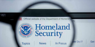 Magnifying glass showing Homeland Security website.
