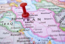 Red pushpin marking Iran on a map.