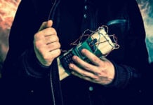 Person holding a homemade explosive device.