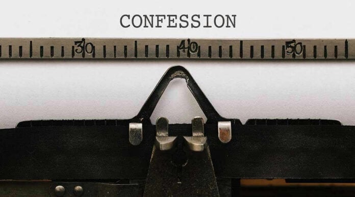 Typewriter with CONFESSION on paper.