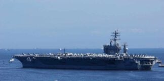 A large aircraft carrier sailing in the ocean