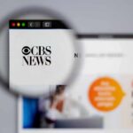 Magnifying glass focusing on CBS News logo on a website