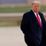 Donald Trump walking outdoors in formal attire