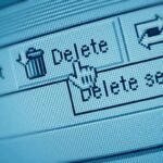 Close-up of a computer screen showing a delete button with a cursor hovering over it