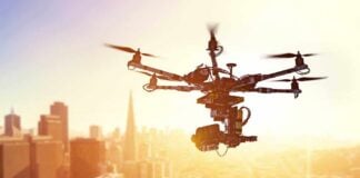 Drone Debris SLAMS Christian Neighborhood A drone flying over a city skyline during sunset