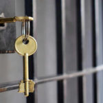 Key in lock of prison cell door.