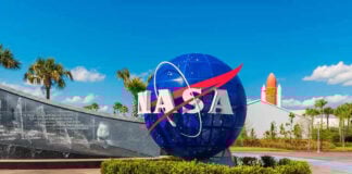 NASA logo sculpture with spaceship and palm trees.