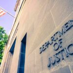 Exterior view of the Department of Justice building with an American flag