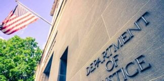 Exterior view of the Department of Justice building with an American flag