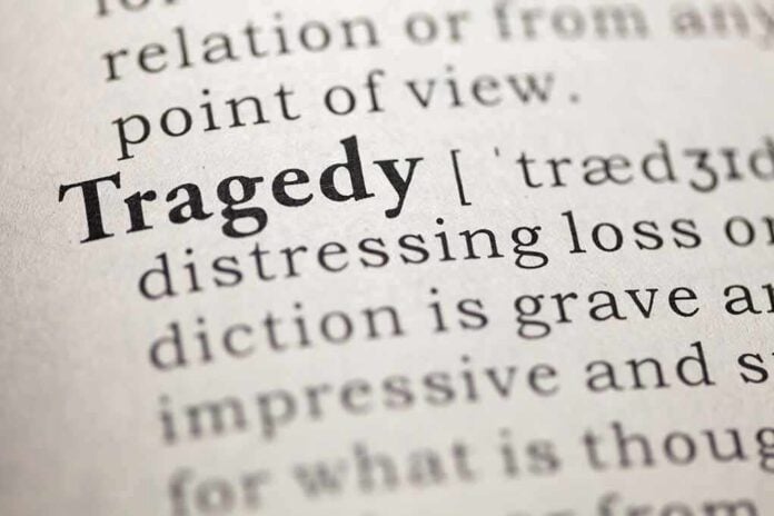 Close-up of the word 'Tragedy' in a dictionary with its definition