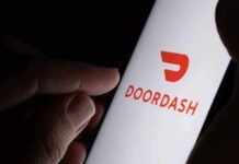Trump’s McDonald’s Delivery by DoorDash Grandma A hand holding a smartphone displaying the Doordash logo