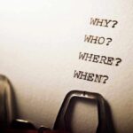 Close-up of a typewritten page with four questions: Why, Who, Where, When