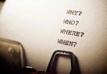 Close-up of a typewritten page with four questions: Why, Who, Where, When