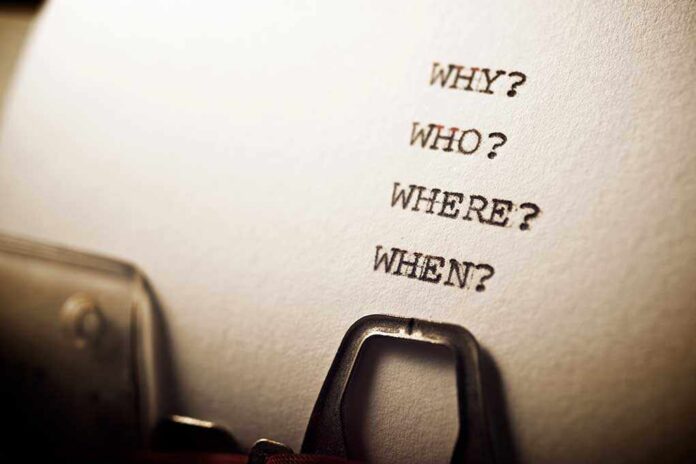 Close-up of a typewritten page with four questions: Why, Who, Where, When