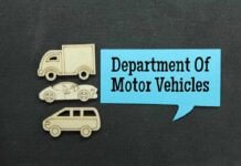 Wooden cutouts of various vehicles with a speech bubble stating Department Of Motor Vehicles