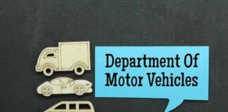 Wooden cutouts of various vehicles with a speech bubble stating Department Of Motor Vehicles