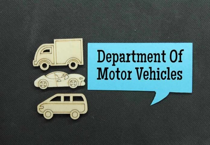 shutterstock_2031934502.jpg Wooden cutouts of various vehicles with a speech bubble stating Department Of Motor Vehicles