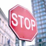 A red stop sign prominently displayed in an urban setting