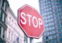 A red stop sign prominently displayed in an urban setting
