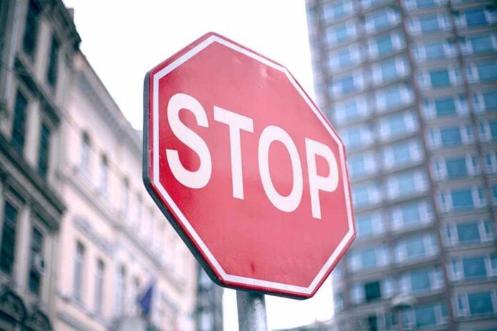 A red stop sign prominently displayed in an urban setting