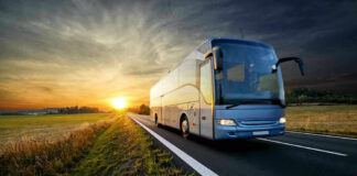 Caltrans’ Daring Pitch: 140 MPH Freeway Buses! Bus driving on a road at sunset.