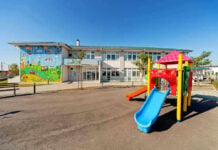 NEW INDICTMENT in Daycare Scandal! Colorful playground slide in front of a building.