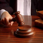Judges gavel on desk with books.