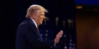 Trump’s 2028 Dream Ticket Bombshell Person speaking at a podium with hand raised