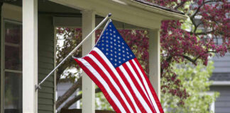 American flag hanging from a porch.