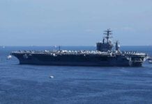 Invasion Panic Explodes — U.S. Silence Deafens A large aircraft carrier sailing in the ocean