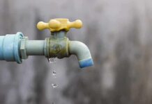 Close-up of a dripping outdoor water faucet