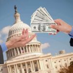 Hands exchanging cash in front of the Capitol building