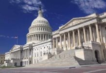 The U.S. Capitol building with its dome and columns under a blue sky