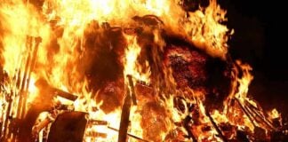 Knife Threat Sparks Fiery Blast–COPS in HARM’S WAY A large fire engulfing debris at night