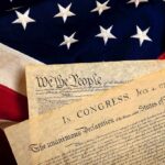 House Speaker Ignites Church-State Showdown The Declaration of Independence laid on an American flag