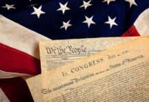 House Speaker Ignites Church-State Showdown The Declaration of Independence laid on an American flag