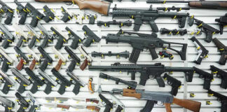 Prosecutor Revolt: Virginia Gun Ban Sparks Buying Surge Wall display of various firearms in a store.