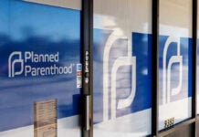 Down Syndrome Abortion Rates Spark Debate Planned Parenthood office entrance with logo and signs.