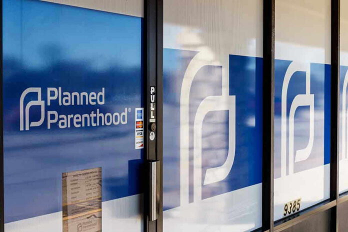 1348319024 Planned Parenthood office entrance with logo and signs.
