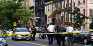 No Arrests Made on Harlem Scooter Crash Police gathered at an urban crime scene.