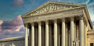 The Signal Deletion That Could Cost Him 20 Years Building with columns and statues in front of entrance.
