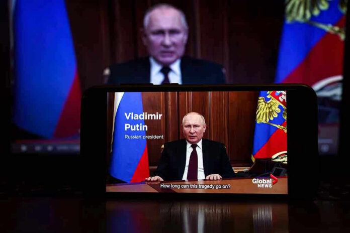 2127643805 Man speaking on screen with Russian flag background.