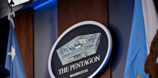 Pentagon Overhauls Faith System The Pentagon emblem between two flags.