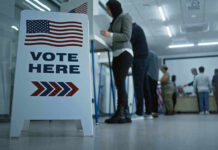 NJ Voting Cases Fuel National Debate Sign reading Vote Here in a polling station.