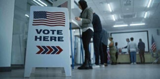 NJ Voting Cases Fuel National Debate Sign reading Vote Here in a polling station.